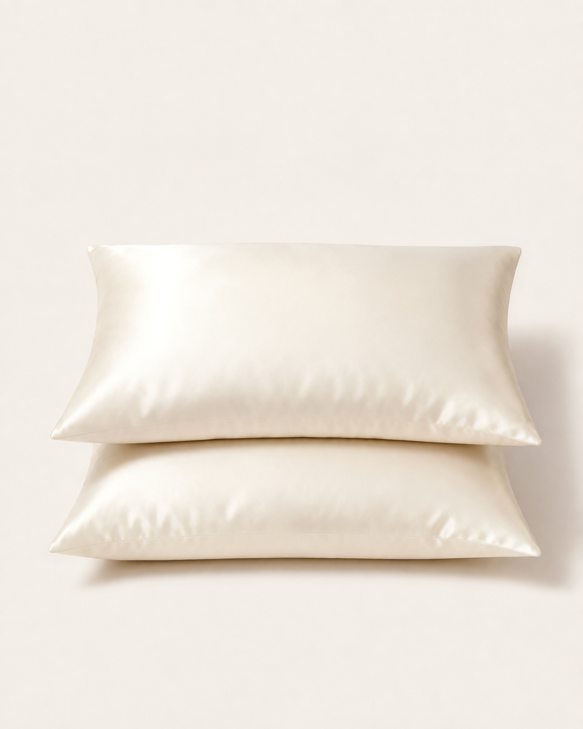 Two ivory mulberry silk pillowcases on pillows