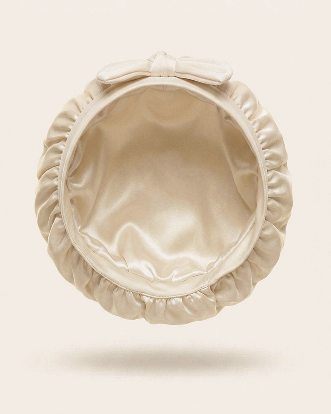 Inside of the ivory silk bonnet, showing the silk lining