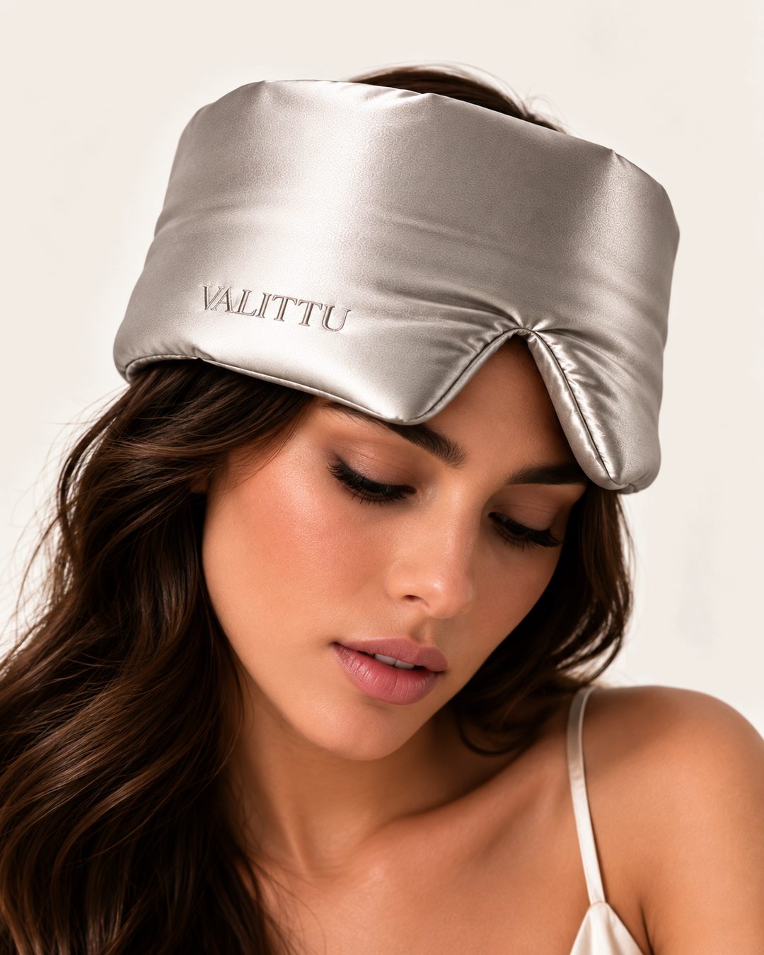 Model wearing the silver silk sleep mask
