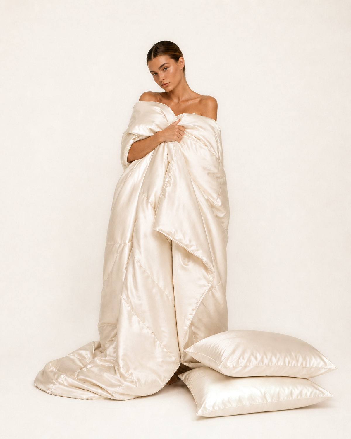 Model wrapped in ivory mulberry silk bedding
