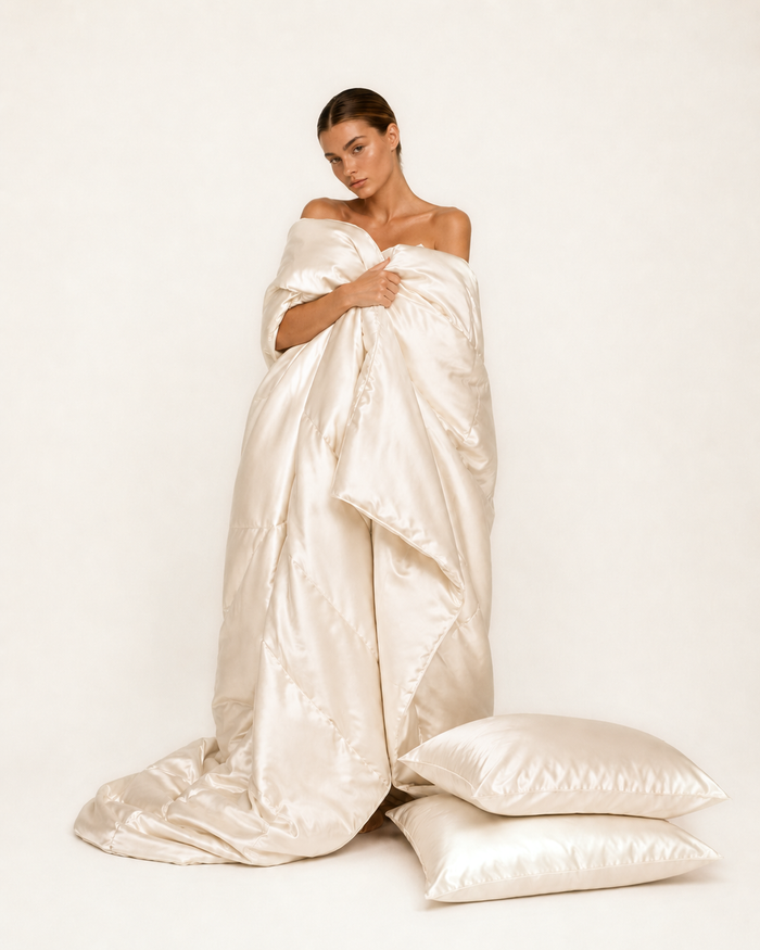 Model wrapped in ivory mulberry silk bedding