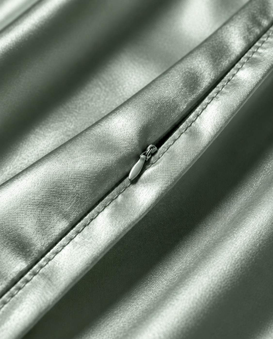 Close-up of the hidden zip closure on the green mist silk pillowcase