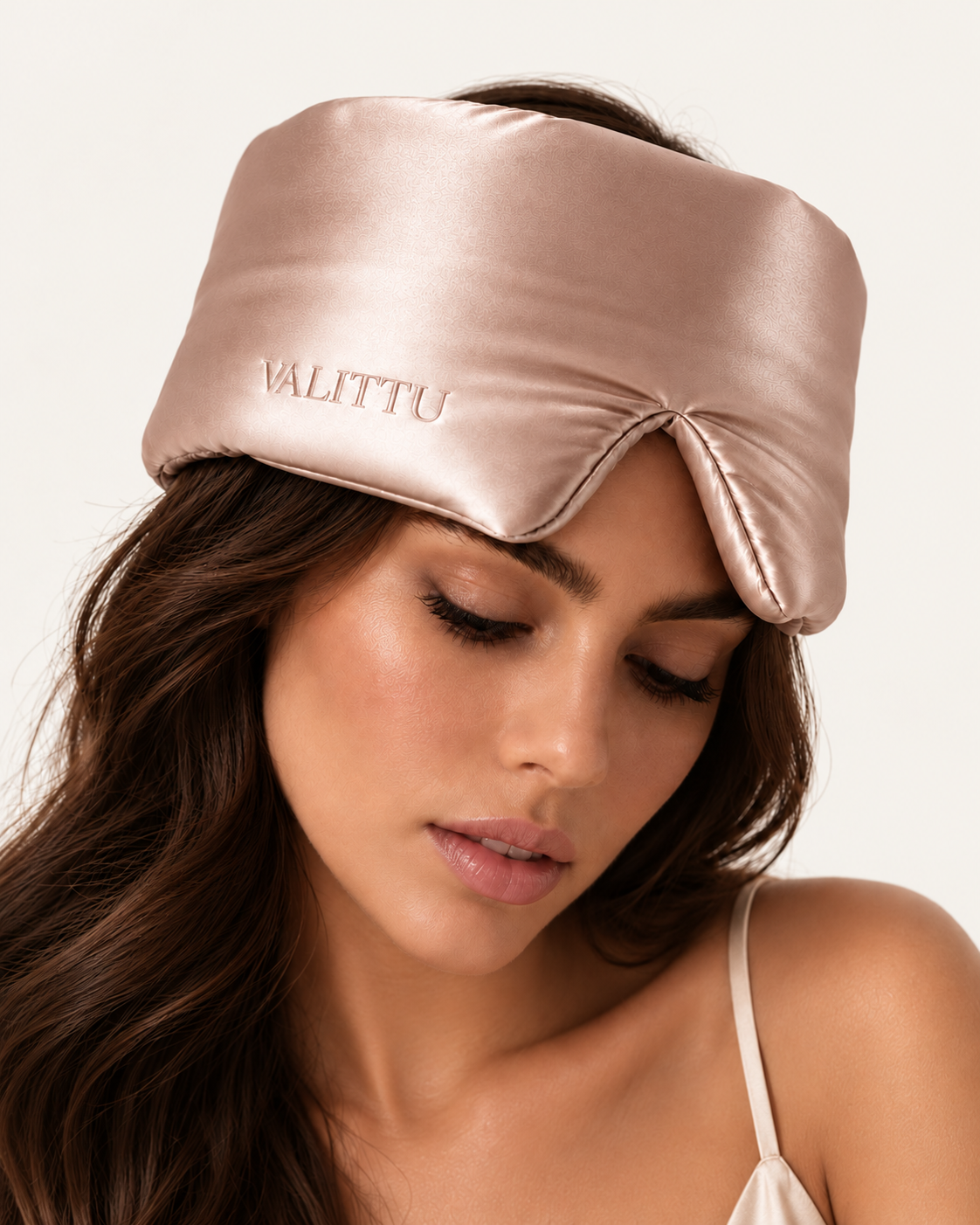 Model wearing the rose gold silk sleep mask