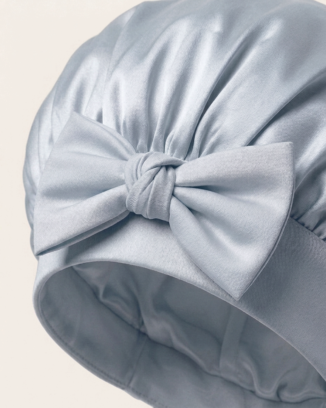 Close-up of the bow on the soft band of the blue mist silk bonnet