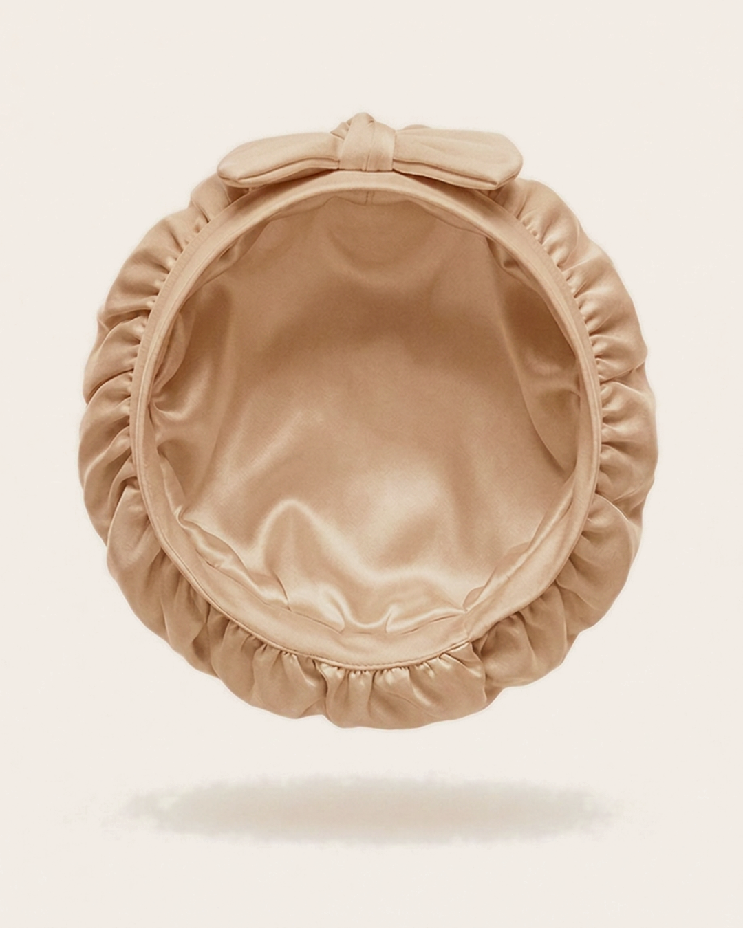 Inside of the rose gold silk bonnet, showing the silk lining