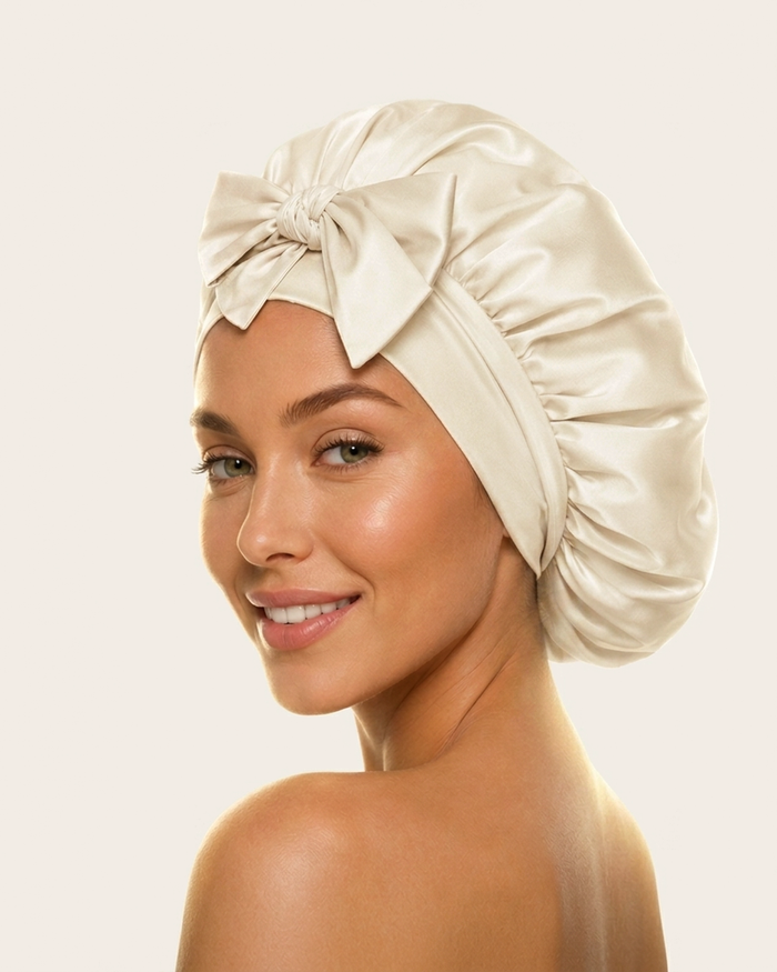 Model wearing the ivory silk bonnet