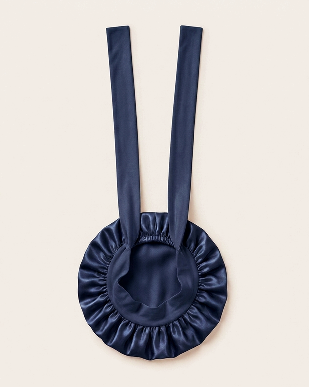 Navy silk bonnet laid flat with its ties extended