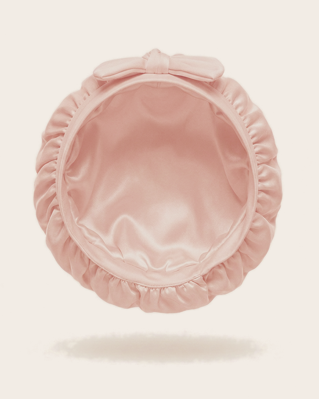 Inside of the pink silk bonnet, showing the silk lining