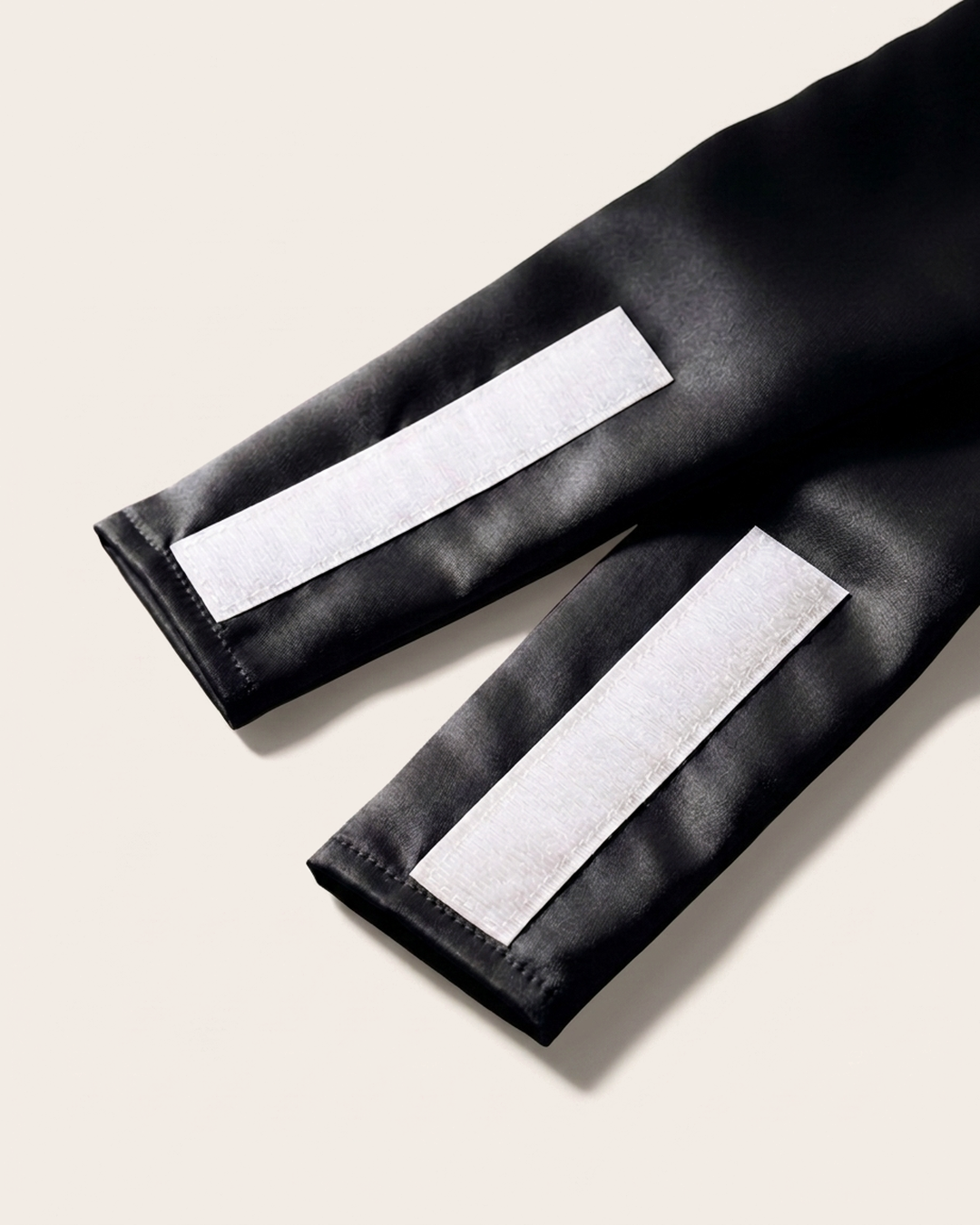 Close-up of the wide silk strap and soft velcro closure on the black sleep mask