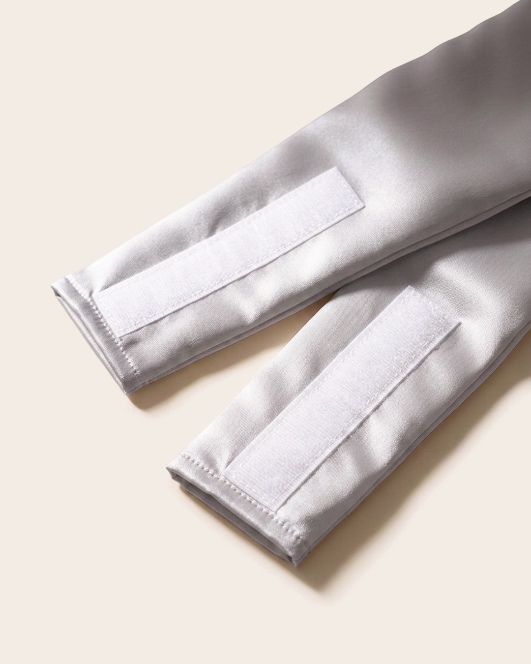 Close-up of the wide silk strap and soft velcro closure on the silver sleep mask